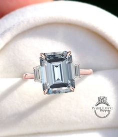 an emerald cut ring with three baguettes on it