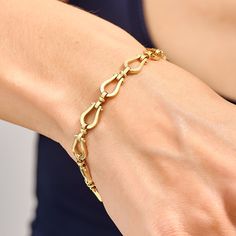 Handcrafted with care, this exquisite piece features a delicate horseshoe charm that exudes timeless charm and grace. The high-quality solid gold chain adds a touch of luxury, making it a perfect accessory for everyday wear or special occasions. Choose from rose gold, white gold, or classic yellow gold in 14 karat options to complement your personal style. This stunning bracelet makes for a thoughtful and meaningful gift for yourself or someone special, symbolizing good fortune and a stylish sta Luxury Gold Horseshoe-shaped Jewelry, Oval Link Bracelets With Clasp, Luxury Gold Horseshoe Jewelry, Luxury Horseshoe Jewelry For Formal Occasions, Luxury Horseshoe-shaped Formal Jewelry, Classic Bangle Charm Bracelet For Formal Occasions, Elegant Charm Bracelet With Spring Ring Clasp, Classic Horseshoe Jewelry, Elegant Gold Charm Bracelet With Clasp