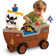 a little boy that is playing with a toy boat