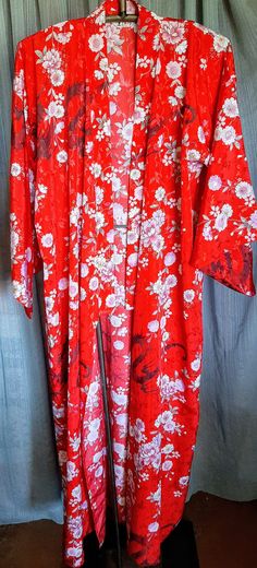 This is a very nice kimono.  It's never been worn and the sash belt is still attached in the sleeve.  Armpit to armpit is 28 inches.  Sale is final Red Open Front Kimono For Spring, Red Robe With Kimono Sleeves For Spring, Elegant Red Kimono For Spring, Red Wrap Kimono For Spring, Red Kimono With Kimono Sleeves For Festival, Traditional Printed Kimono For Spring, Long One Size Floral Print Kimono, Red One Size Kimono For Festival, Red Wrap Kimono For Festivals