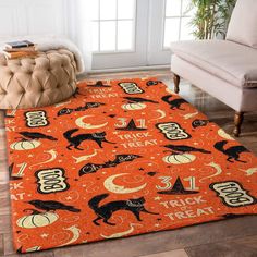 an orange area rug with black cats and pumpkins on it in front of a couch