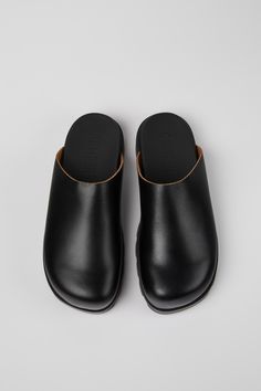 Modern Black Clogs With Cushioned Footbed, Functional Black Clogs With Rubber Sole, Modern Leather Clogs With Leather Footbed, Leather Clogs With Ortholite Insole For Outdoor, Modern Leather Clogs With Rubber Sole, Modern Slip-on Clogs, Outdoor Leather Clogs With Branded Insole, Modern Black Clogs With Removable Insole, Modern Round Toe Clogs For Outdoor