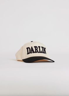 Such an iconic hat! Trucker hats are all the rave this season and we couldn't be more excited! DARLIN' Brand is based out of California and these incredible trucker hats are made in the USA! 3D Embroidered "DARLIN'" Mid profile snapback Adjustable snapback closure One size fits most Structured Firm Front Panel 65% Polyester 35%Cotton Retro Short Brim Snapback Hat For Streetwear, Retro Snapback Hat With Short Brim For Streetwear, Us Labor Day, Childrens Shop, Beach Collection, Top Graphic Tees, Ball Cap, Western Wear, Beach Trip