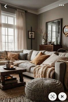 a living room filled with lots of furniture next to a large window on top of a rug