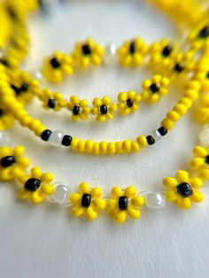 yellow and black beaded necklaces on white surface