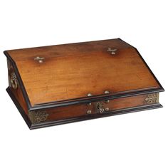 an old wooden box with metal handles on it's sides and wood lining the lid