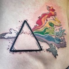 a woman's stomach with a triangle and unicorns tattoo on the side of her belly