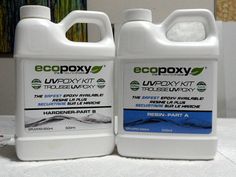 two gallon jugs of ecopoxy liquid sitting on a table next to each other