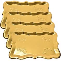 four gold foiled trays with ornate designs on the bottom and sides, one is empty