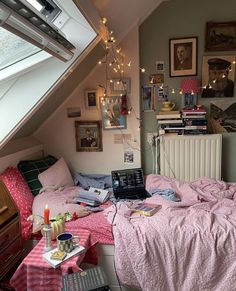 a bedroom with a bed, laptop and pictures on the wall next to each other