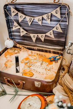 an open suitcase sitting on top of a table next to other items and decorating