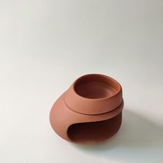 a brown vase sitting on top of a white table