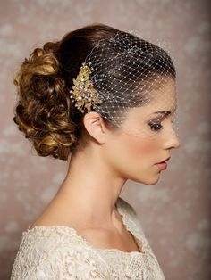 a woman wearing a veil and hair comb