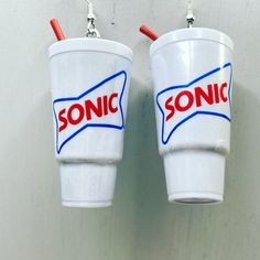 two plastic cups with sonic logo hanging from hooks