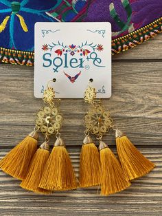 These Beautiful Mexican Earrings are made with the Mexican art form of twisting gold plated wires to create beautifully intricate works of art. The silk thread tassel adds that beautiful pop of color to any outfit. These earrings are handmade by Mexican Artisans. Dangle Tassel Earrings For Festivals, Gold Fringe Chandelier Earrings As Gift, Festival Tassel Dangle Earrings, Gold Tassel Dangle Earrings, Elegant Yellow Tassel Earrings For Gift, Gold Bohemian Earrings With Fringe, Traditional Gold Fringe Jewelry, Bohemian Gold Fringe Earrings, Bohemian Gold Tassel Earrings Gift