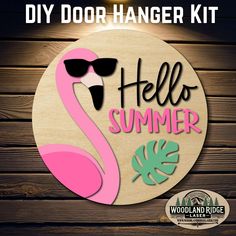 the diy door hanger kit includes a pink flamingo and palm leaves on it