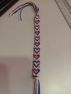 a red, white and blue tie on a table