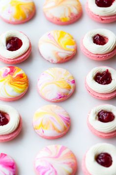 an image of colorful macaroons with icing on them