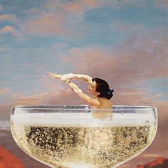 a painting of a woman floating in a large glass filled with liquid and gold flakes