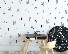 a black and white wall with lightning bolt decals next to a small desk in front of it