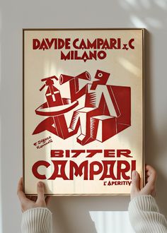 a person holding up a poster in front of a window with the words, bitter campari on it