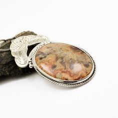 "Crazy lace agate necklace sterling silver large oval lace agate pendant orange brown beige antique bohemian style, artisan boho jewelry A beautiful large oval crazy lace agate stone with hues of brown, beige and orange in sterling silver statement pendant. Lovely autumn colors and winter colors too. The stone is set inside a bezel and framed with braided wire . On top of it there is an engraved antique floral pattern. I have oxidized it to bring out the details and achieved this bohemian look T Earthy Brown Round Pendant Jewelry, Artisan Jasper Jewelry In Oval Shape, Artisan Oval Jasper Jewelry, Bohemian Agate Necklace With Large Stone, Handmade Jasper Oval Necklaces, Handmade Oval Jasper Necklaces, Bohemian Medallion Jewelry With Natural Stones, Handmade Jasper Oval Necklace, Handmade Oval Jasper Necklace