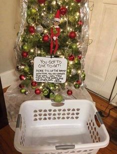 a christmas tree decorated with ornaments and a sign that says, you got to give to get