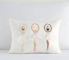 three little ballerinas on a white pillow