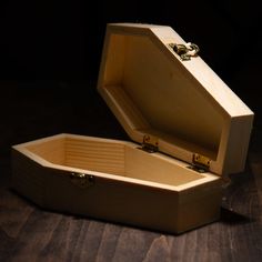 an open wooden box sitting on top of a table