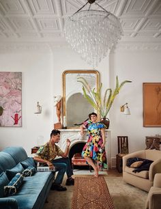 a man and woman sitting on couches in a living room