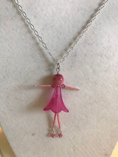 This ballerina necklace is made with a pink glass bead for the head and a lucite flower bead for the body. The arms and legs are made with Miyuki Delica beads. The hands and feet are made with pink Swarovski crystals. The ballerina pendant is 3 3/4 inches long and comes on a 16in silver colored chain. If you have any questions feel free to email hannahsjeweltique@gmail.com Thanks for stopping by. Whimsical Pink Beaded Necklaces For Party, Whimsical Pink Beaded Necklace For Party, Whimsical Pink Beaded Necklaces For Gifts, Whimsical Pink Beaded Necklaces As Gift, Pink Glass Beaded Necklaces For Gift, Pink Glass Beaded Necklace For Gift, Handmade Pink Glass Beaded Necklaces, Ballerina Necklace, Pineapple Bracelet