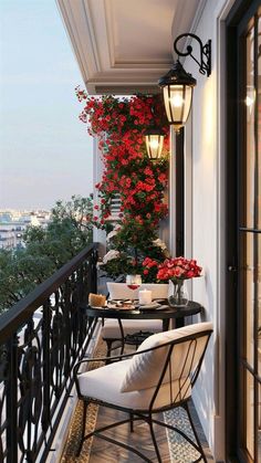 a balcony with flowers and chairs on it