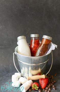 a metal bucket filled with lots of different types of drinks