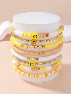 a stack of bracelets with smiley faces on them