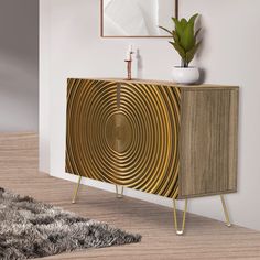 a modern sideboard with an abstract design in gold and white, sits on a wooden floor next to a potted plant