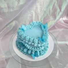 a blue cake sitting on top of a white plate