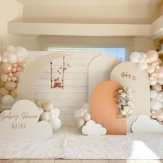 a room with balloons and decorations on the walls, including an arch that says happy birthday mama