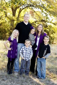 a family posing for a photo in the grass