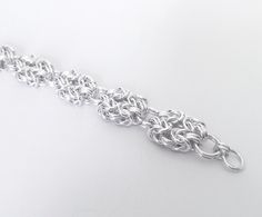 "Handmade heavy sterling silver bracelet. Polished silver. Traditional viking king chainmaille with intermittent bigger rings. Width 15 mm (approx 5/8\"). If you prefer the antique look an oxidized variation is also available. Order 2.5 cm (1\") longer than the intended wearers wrist for a proper fit. Matching necklace: https://www.etsy.com/listing/805992866 You order not the exact item on the image, but it's likeness to your specified length. Please contact the shop owner for other dimensions t Silver Chainmail Bracelet As A Gift, Silver Chainmail Chain Bracelet As Gift, Viking King, Chain Jewellery, Norse Jewelry, Chainmaille Bracelet, Viking Bracelet, Silver Chain Style, Big Rings