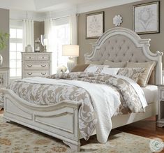 a white bed sitting in a bedroom on top of a hard wood floor