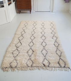 a white rug on the floor in a room