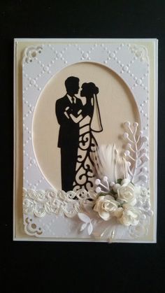 a wedding card with a silhouette of a bride and groom holding a bouquet in their hands