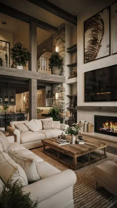 a living room filled with furniture and a flat screen tv mounted on the wall above a fire place