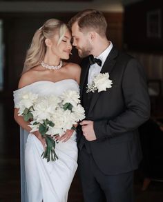 a bride and groom pose for a wedding photo