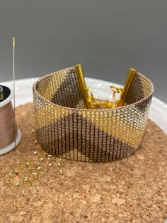 a spool of thread sitting on top of a cork coaster next to a spool of thread