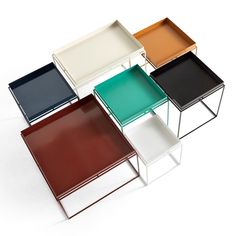 four different colored trays sitting on top of each other