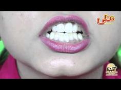 a woman with pink lipstick and white teeth