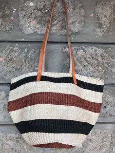 A beautiful brown and white stripes handbag made of sisal with leather handles.Made of extrafine grain sisal.Great for a day out or a gift to loved one.DimensionsLargeShipmentShips via DHLTakes 3-7 days depending with the destinationWholesale ordersAvailableCustom ordersAvailableThank you so much for shopping with us! Striped Rectangular Bag With Braided Handles, Striped Rectangular Straw Bag With Braided Handles, Everyday Handwoven Striped Bags, Handwoven Striped Bags For Vacation, Handwoven Striped Bags For Everyday Use, Handwoven Striped Beach Bags, Striped Straw Bag With Braided Handles For Shopping, Striped Straw Shopping Bag With Braided Handles, Striped Rectangular Vacation Bag