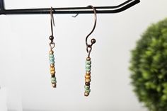 Listing is for 1 pair of dangle earrings.  Adorable and dainty earrings, these Boho earrings are simple and cute. A minimalist's dream! These earrings will be your every day earrings. Simple stick earrings are made with Picasso seed beads and glass beads that hang from unique copper-colored nickel-free ear wires.  Your Bohemian style will really shine through with these cute earrings. Perfect with any outfit - casual, business or special occasion. These dainty earrings are so sweet - they would also make a great gift for her, gift for sister, gift for friend, gift for mom, unique gift for teen, unique birthday gift, unique Christmas gift and a great stocking stuffer.  Want to save on shipping costs? Spend more than $35 and receive FREE shipping! Love these handmade earrings and want to see Handmade Minimalist Beaded Dangle Earrings, Handmade Dangle Cartilage Earrings For Everyday Wear, Minimalist Beaded Drop Earrings, Bohemian Single Beaded Earring For Everyday Wear, Minimalist Summer Earrings With Ear Wire, Adjustable Minimalist Earrings For Summer, Minimalist Beaded Earrings For Everyday, Minimalist Adjustable Earrings For Summer, Everyday Drop Beaded Earrings