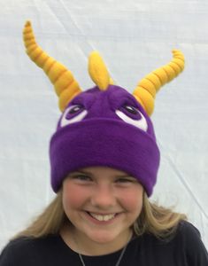 This fabulous Spyro dragon  beanie makes a wonderful addition to your silly hat collection. You know you need one in your life! Yellow horns are stuffed with toy stuffing and spiralised with orange thread. All beanies are hand made from a top quality fleece with plenty of stretch to ensure a perfect fit. There are four sizes available. Small - baby 6-18m Medium- 2-12 years  Medium long - teens and adult female  Large - adult male. Spyro Costume, Dragon Hat, Felt Dragon, Dragon Hats, Pig Costumes, Silly Hats, Spyro The Dragon, Dragon Costume, Pig Party